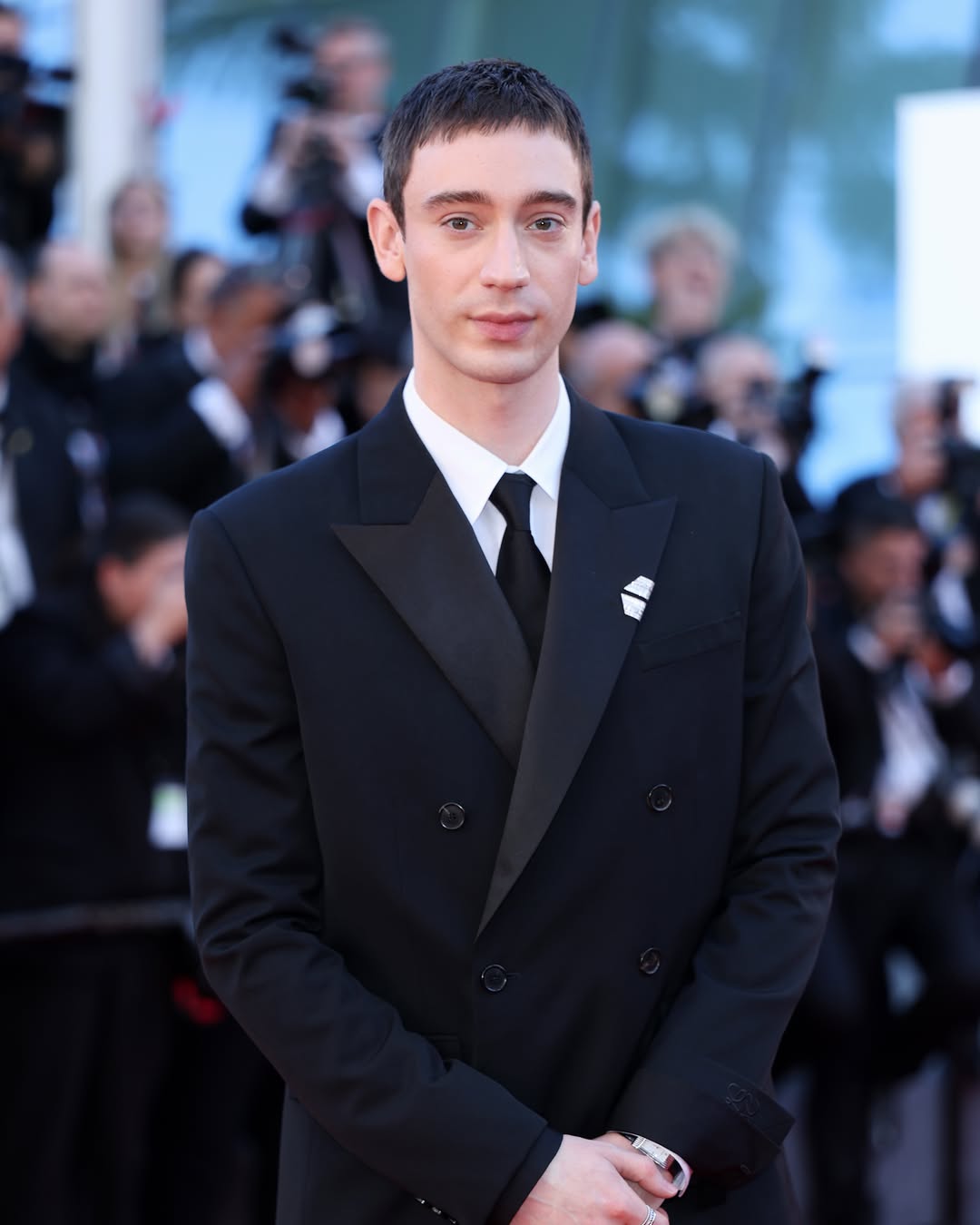 Theodore Pellerin at Cannes Film Festival 2026 wearing a Boucheron brooch and Loewe suit